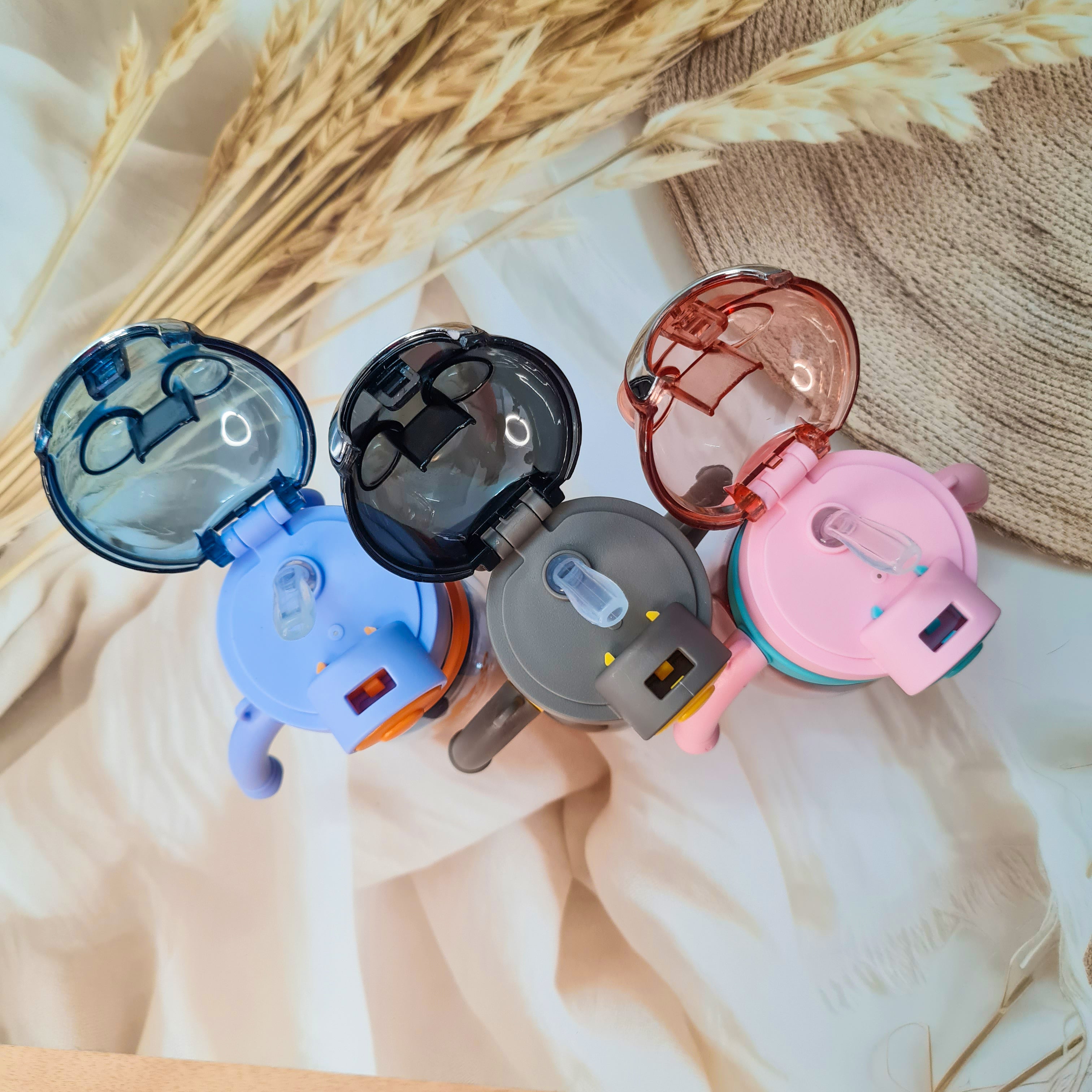 Three plastic water bottles designed with bear motifs, each with a carrying strap and handles in various colors. www.usmile.toys